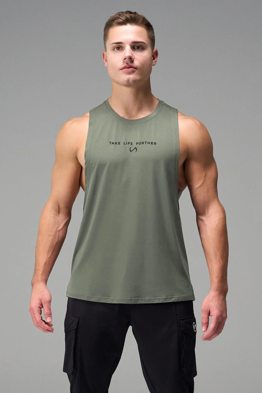 Green Further Air-Flex Drop Arm Tank showing ultra-soft performance fabric and Take Life Further® chest logo detail by TLF Apparel – detail view
