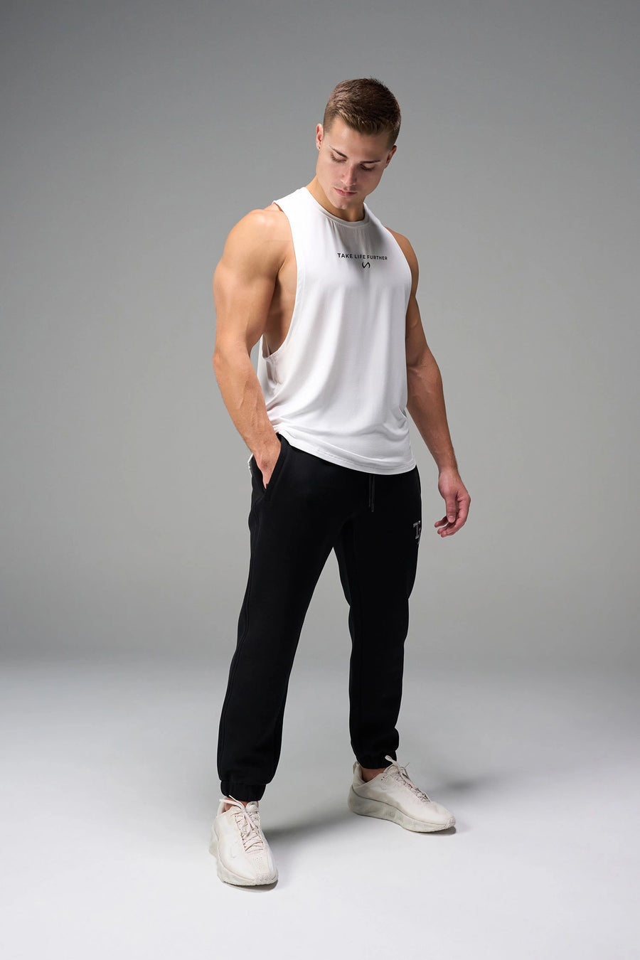 White Further Air-Flex Drop Arm Tank showing drop arm silhouette and breathable performance fabric by TLF Apparel – side view