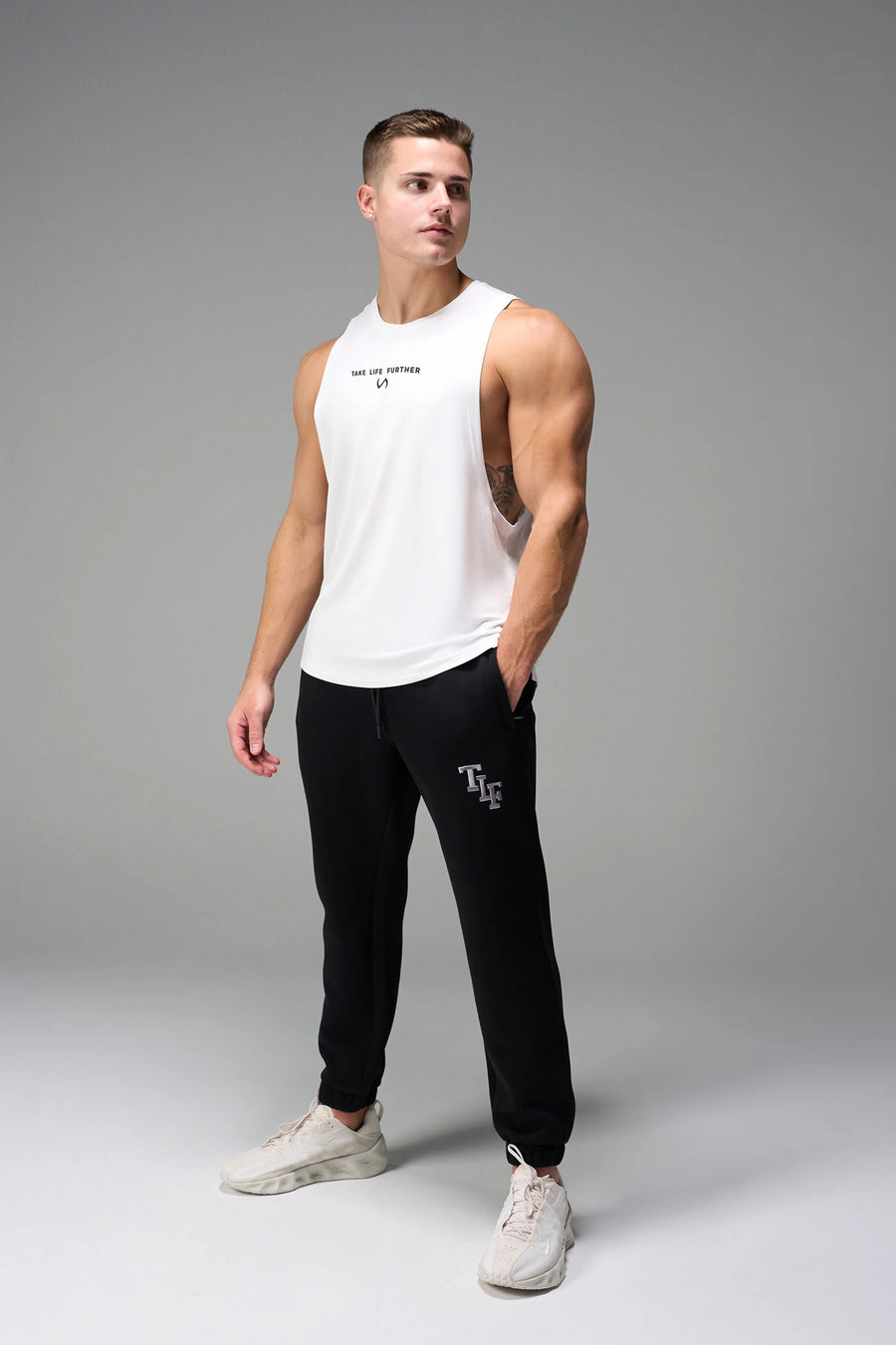 White Further Air-Flex Drop Arm Tank breathable performance tank designed for training and Gym-To-Street® wear by TLF Apparel – front view