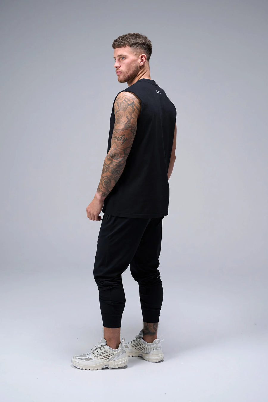 Black Stone Wash Property Of Dura Cotton Muscle Tank showing boxy streetwear fit, raw edge armholes and heavyweight cotton by TLF Apparel – side view