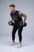 Black Stone Wash Property Of Dura Cotton Muscle Tank showing raw-cut armholes, wide shoulder fit and stone wash finish by TLF Apparel – front view