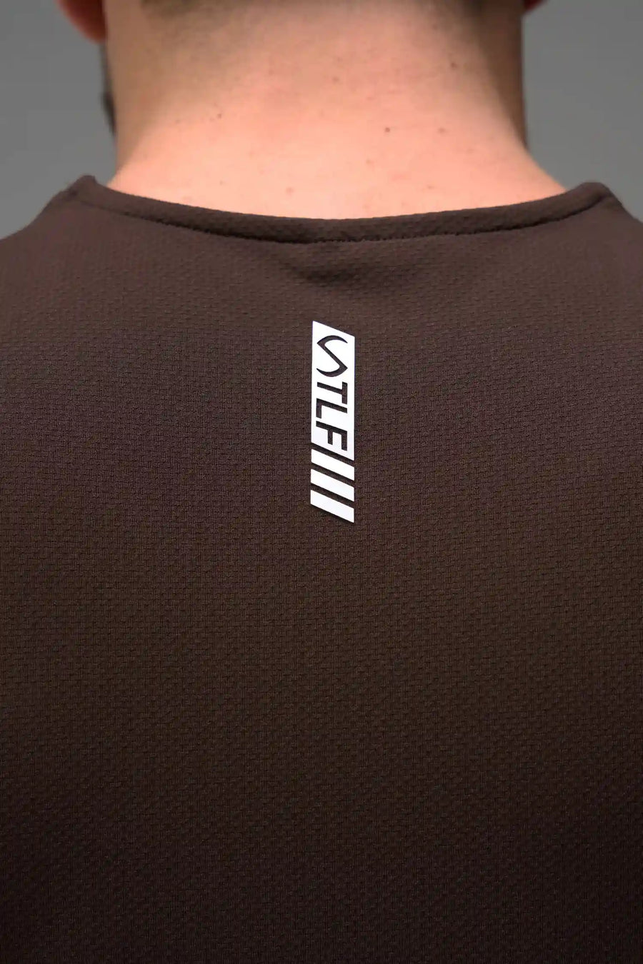 Brown Men’s Micro Mesh Tank with a physique-enhancing fit, designed for gym training, HIIT workouts and running by TLF Apparel – back view 