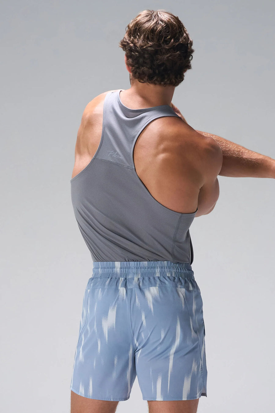 Gray Pluma UPF Tank showing UV color-changing back logo and Pluma Tech DNA fabric by TLF Apparel – back view