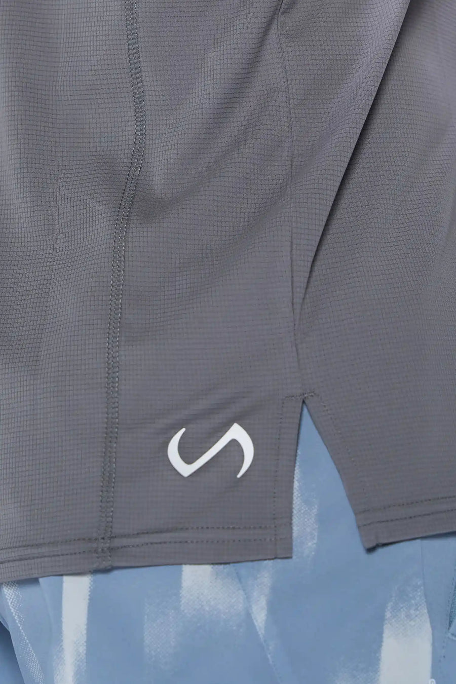 Gray Pluma UPF Tank showing Pluma Tech DNA micro-grid knit and UV color-changing logo by TLF Apparel – detail view