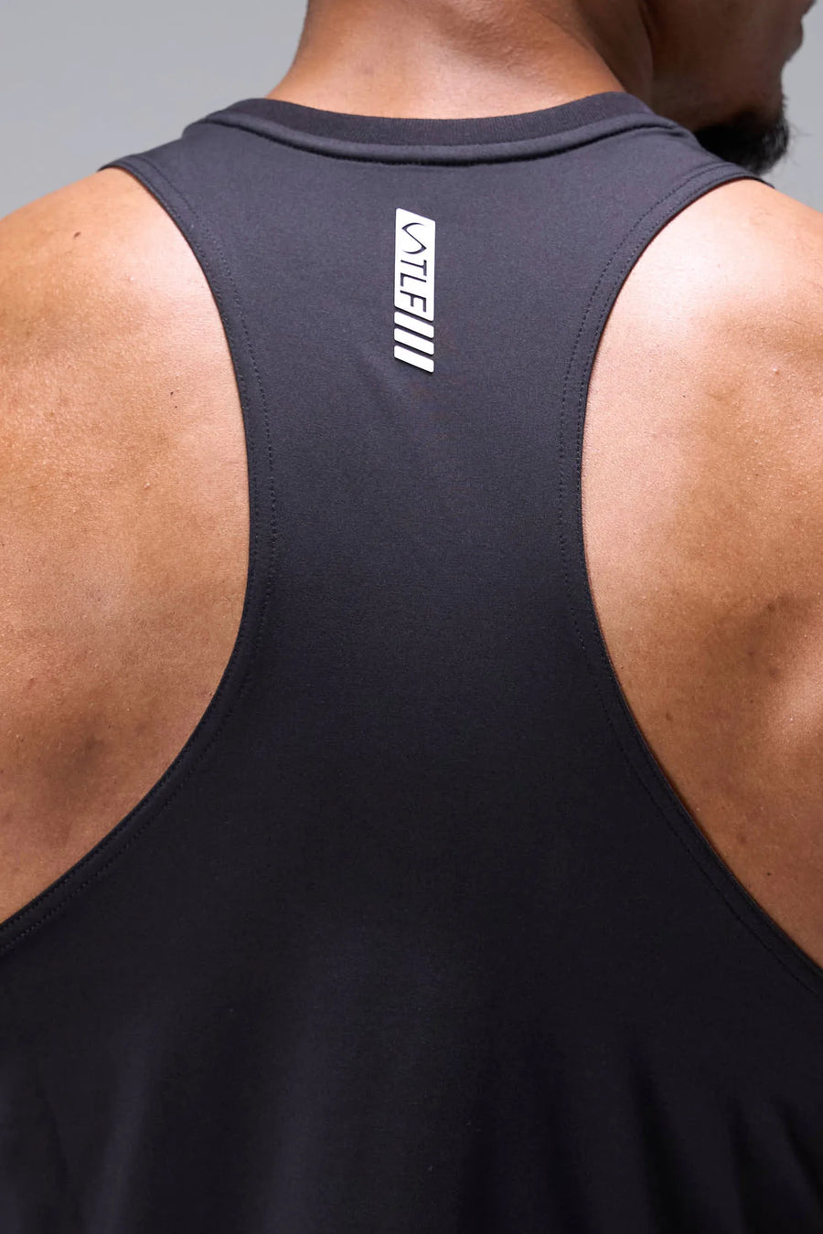 Black Infi-Dry Muscle Tank with breathable sweat-wicking fabric, athletic muscle fit, and signature motion logo by TLF Apparel – back view