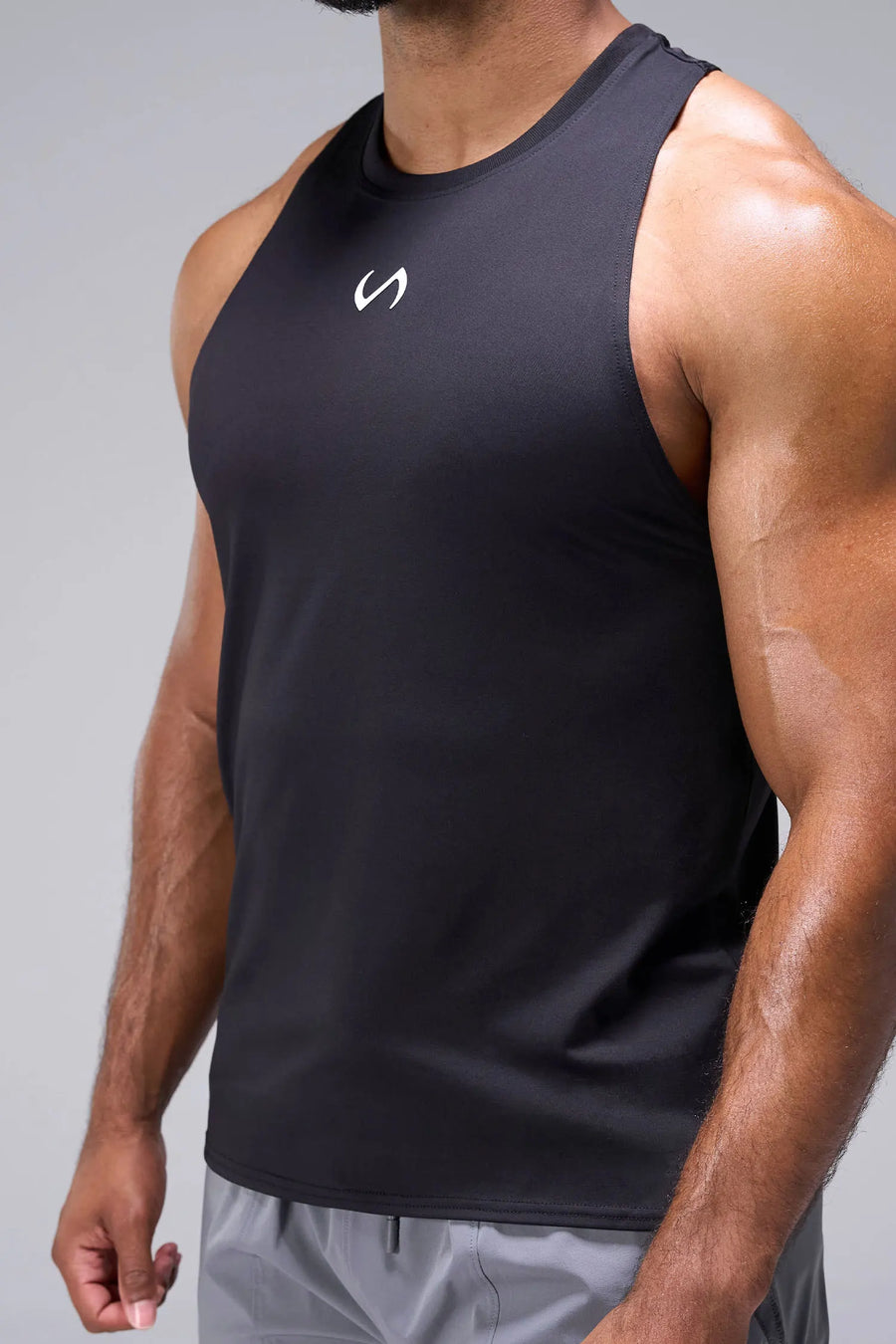 Black Infi-Dry Muscle Tank with drop armhole construction, athletic fit, and unrestricted mobility for training by TLF Apparel – side view
