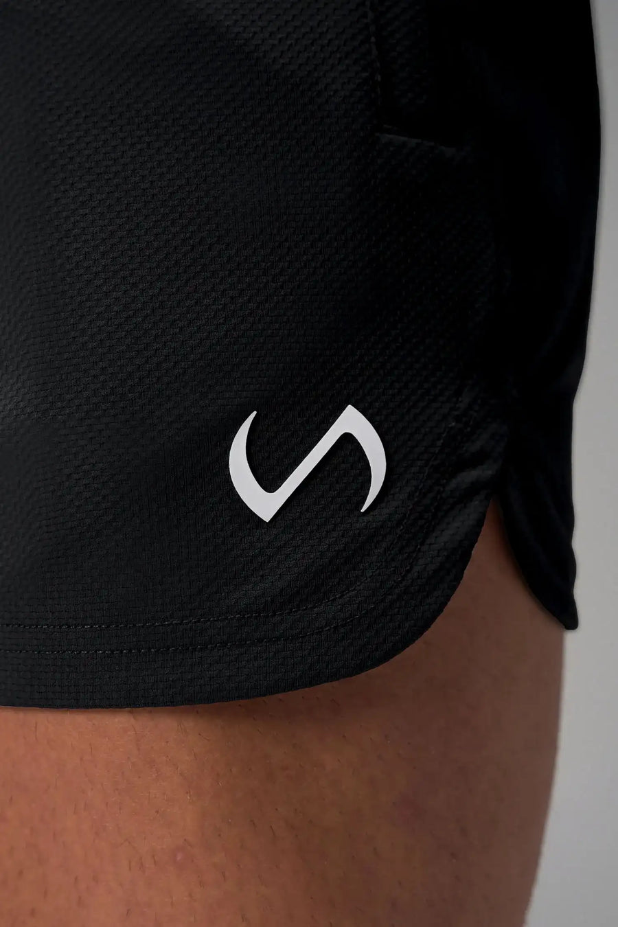 Black Men’s Micro Mesh 5 Inch Shorts with 7-inch inseam, designed for gym training, HIIT workouts and running by TLF Apparel – logo view 