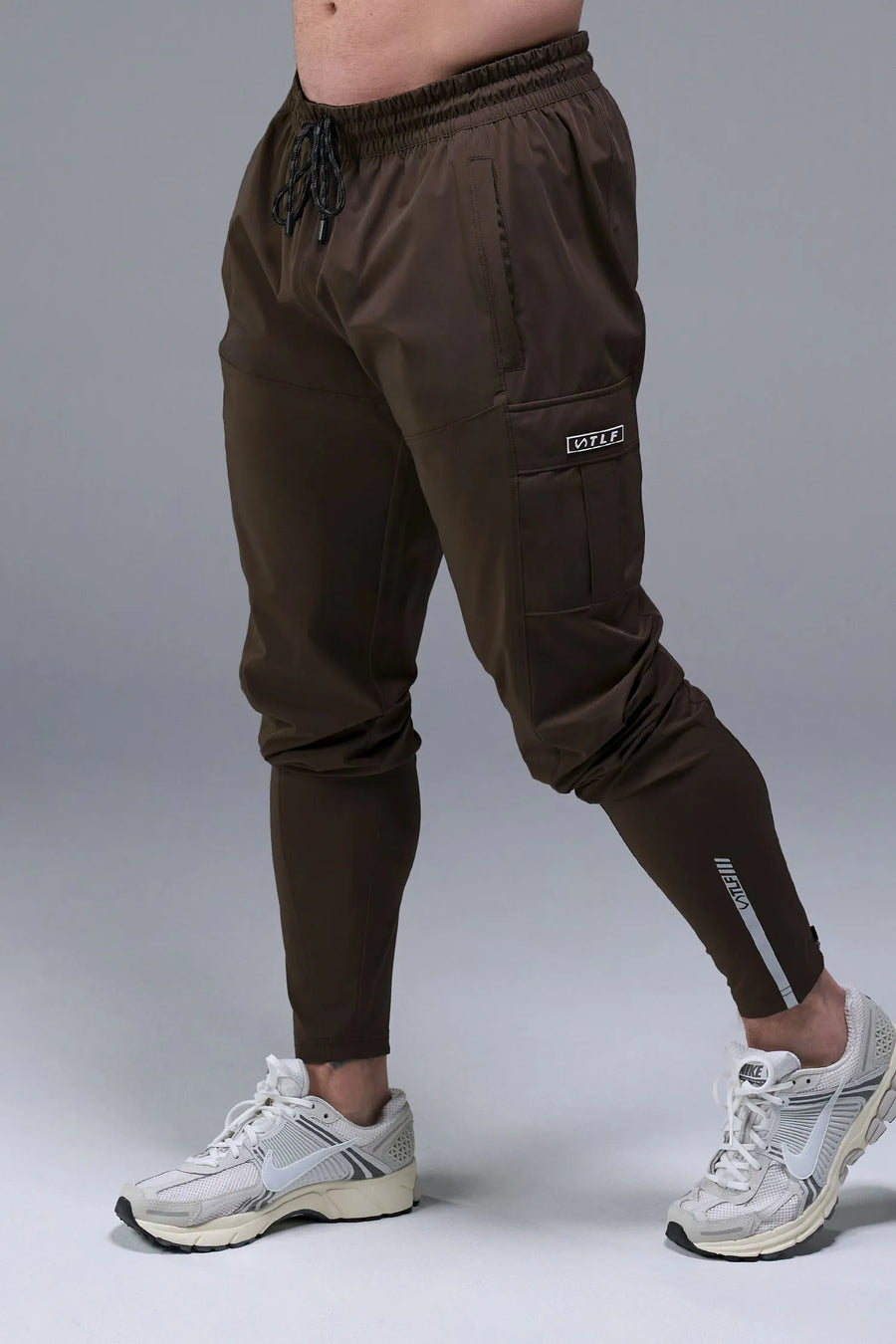 Front View of Brown TLF Element Athletic Joggers 2.0, featuring side zipper pockets and side leg cargo pockets and reflective details 