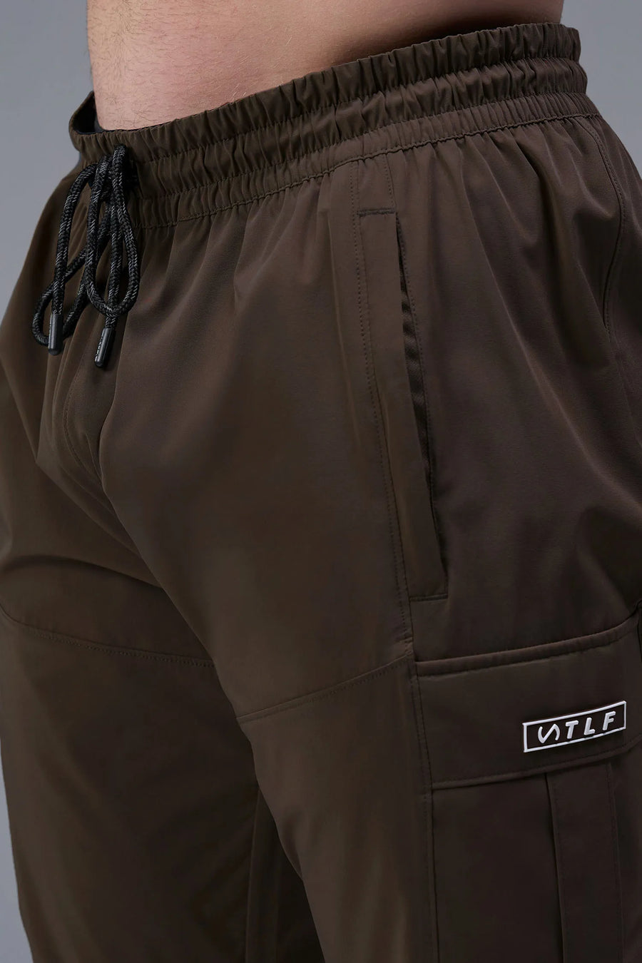 Front View of Brown TLF Element Athletic Joggers 2.0, featuring side zipper pockets and side leg cargo pockets and reflective details 
