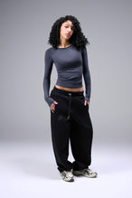 Women’s armada essential seamless long sleeve top with contouring fit for gym and lifestyle by TLF Apparel – full body hands in pocket front view