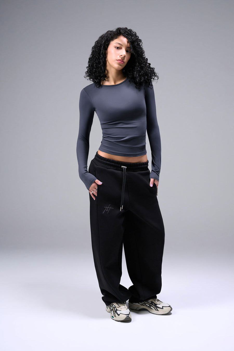 Women’s armada essential seamless long sleeve top with contouring fit for gym and lifestyle by TLF Apparel – full body hands in pocket front view