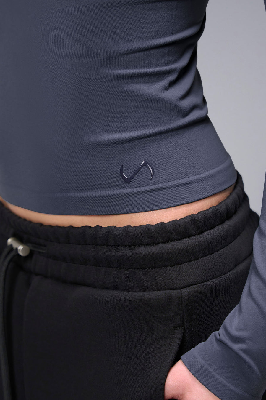 Women’s armada essential seamless long sleeve top with contouring fit for gym and lifestyle by TLF Apparel – detail logo view