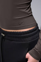 Women’s dark oak essential seamless long sleeve top with contouring fit for gym and lifestyle by TLF Apparel – detail logo view