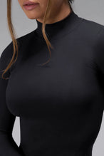 Detail View of Black TLF Essential Seamless Mock Neck Long Sleeve, featuring thumbholes and mock neck for gym to street versatility