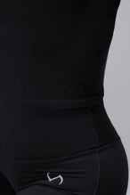 Detail Side View of Black TLF Essential Seamless Mock Neck Long Sleeve, featuring thumbholes and mock neck for gym to street versatility