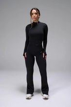 Front View of Black TLF Essential Seamless Mock Neck Long Sleeve, featuring thumbholes and mock neck for gym to street versatility