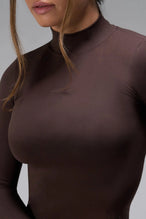 Detail View of Brown TLF Essential Seamless Mock Neck Long Sleeve, featuring thumbholes and mock neck for gym to street versatility