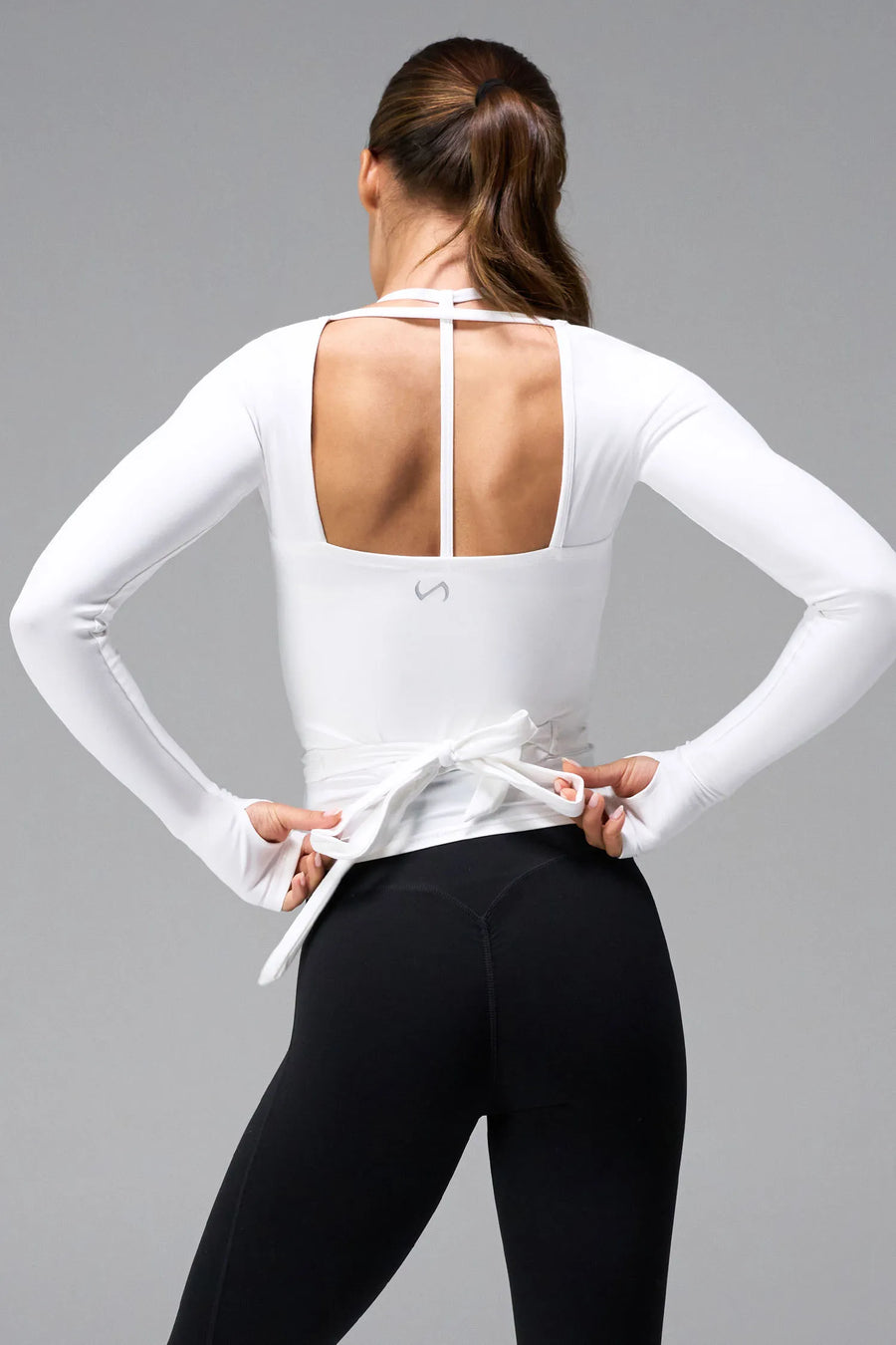 White NeoCloud™ wrap top with long sleeves and wrap design for multiple styling options by TLF Apparel – back view 