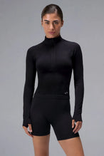 Black Cosmic Seamless 1/4 Zip, seamless long sleeve workout top with cropped fit and quarter zip neckline for gym training and workouts by TLF Apparel – front view 