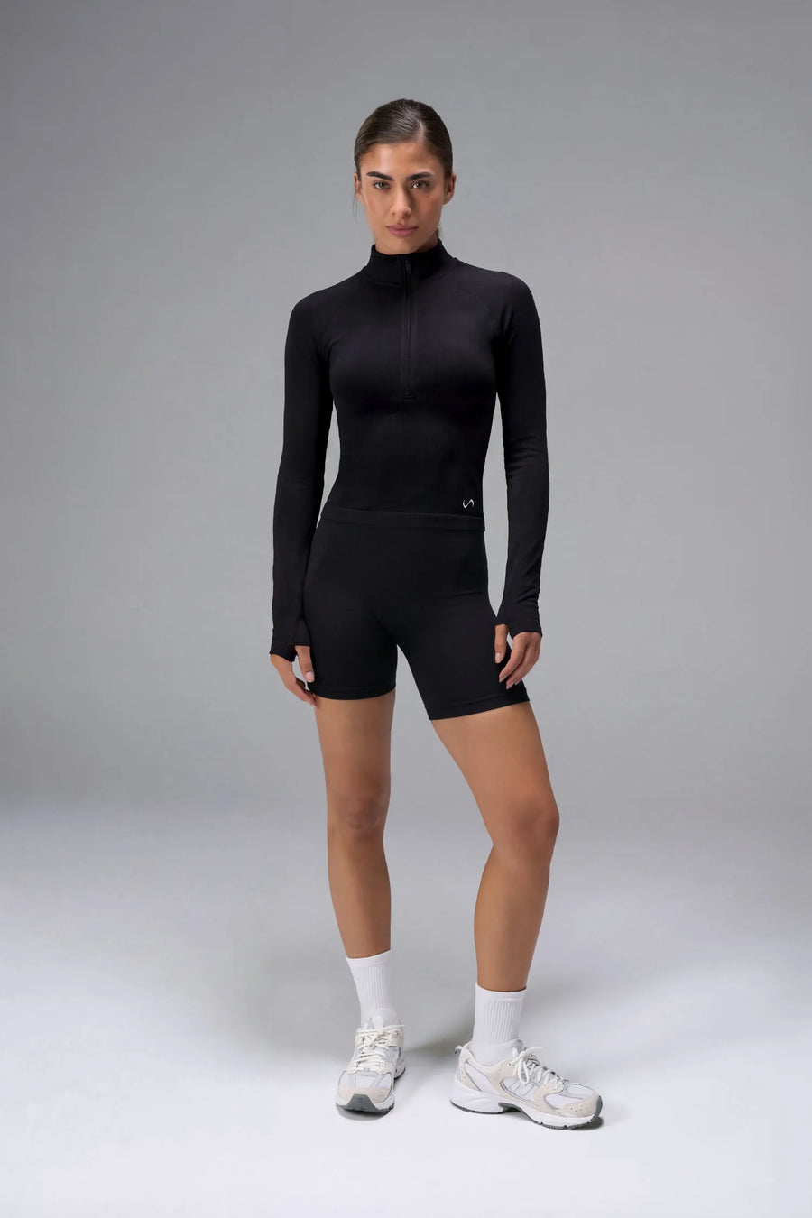 Black Cosmic Seamless 1/4 Zip with raglan sleeves and seamless sculpting fit for workouts and training by TLF Apparel – front view 