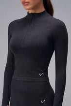 Black Cosmic Seamless 1/4 Zip with sculpting seamless fabric for workouts and training by TLF Apparel – front view
