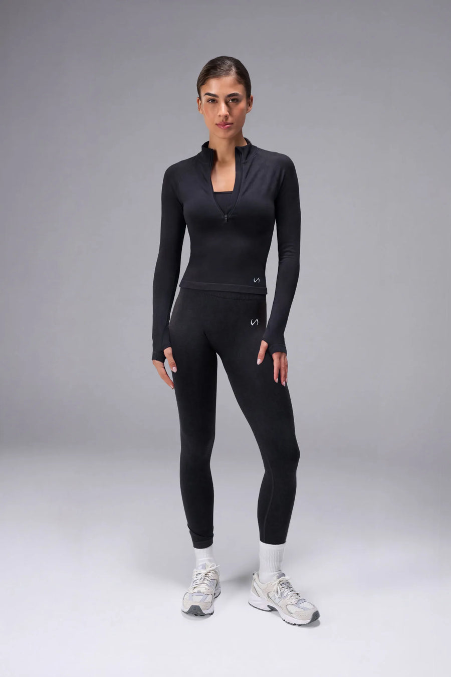 Black Cosmic Seamless 1/4 Zip with raglan sleeves and seamless sculpting fit for workouts and training by TLF Apparel – front view 