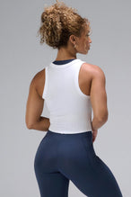 White Essential Ribbed Tank Top showing sculpting fit and clean back silhouette by TLF Apparel – back view