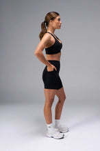 Black Tempo 6 Inch Gym Shorts With Pockets showing sculpted fit and mid thigh length by TLF Apparel – side view