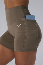 Brown Tempo 6 Inch Gym Shorts With Pockets showing Luxe DNA™ fabric and Hi-Tech Gel TLF logo by TLF Apparel – detail view