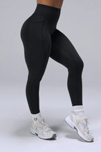 Black Tempo Leggings With Pockets showing sculpted thigh and full-length leg silhouette by TLF Apparel – side view