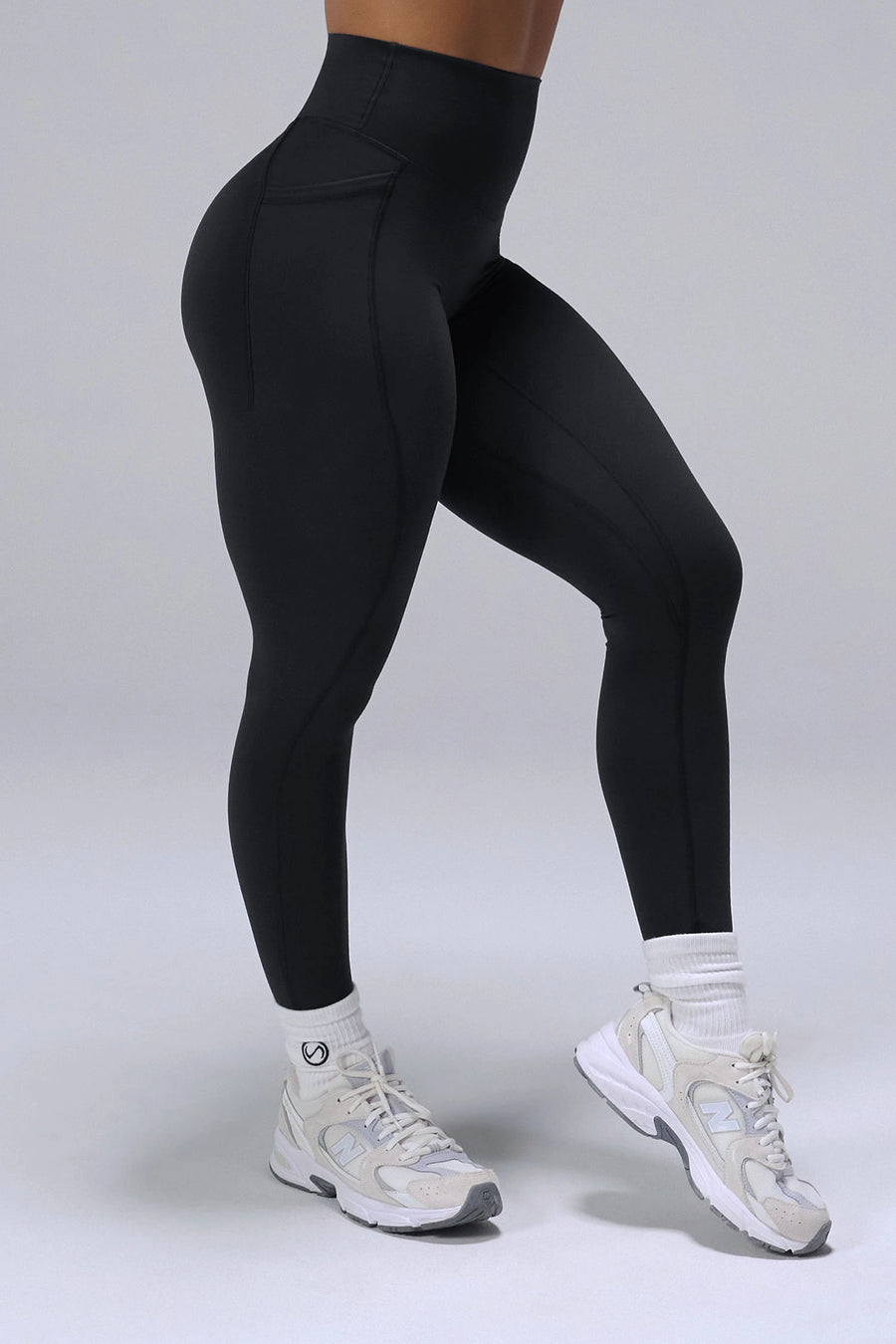 Black Tempo Leggings With Pockets showing sculpted thigh and full-length leg silhouette by TLF Apparel – side view