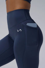 Navy Tempo Leggings With Pockets showing Luxe DNA™ fabric texture and Hi-Tech Gel TLF logo by TLF Apparel – detail view