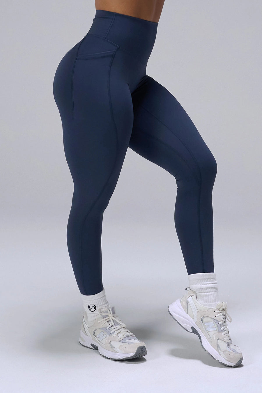 Navy Tempo Leggings With Pockets showing sculpted thigh and full-length leg silhouette by TLF Apparel – side view