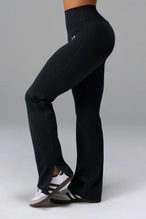Side View of Black TLF Tempo High Waisted Split Hem Leggings feature our Luxe DNA fabric with a side split hem for style versatility