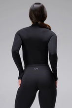 Back View of Black TLF Tempo High Waisted Split Hem Leggings feature our Luxe DNA fabric with a side split hem for style versatility