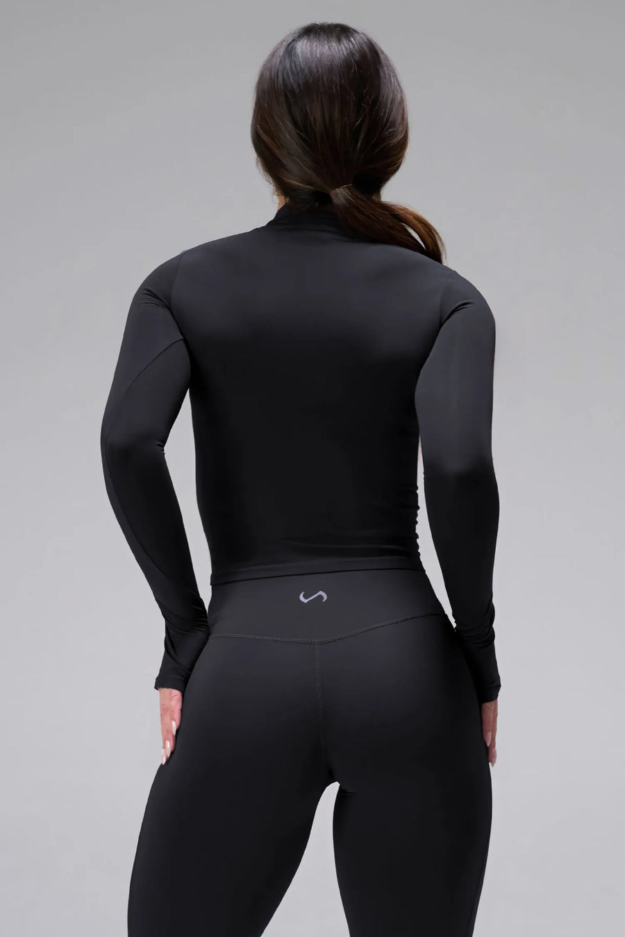 Back View of Black TLF Tempo High Waisted Split Hem Leggings feature our Luxe DNA fabric with a side split hem for style versatility
