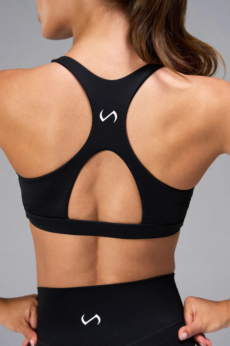 Black Tempo Front Clasp Sports Bra with supportive racerback design and medium support for training by TLF Apparel – back detail view