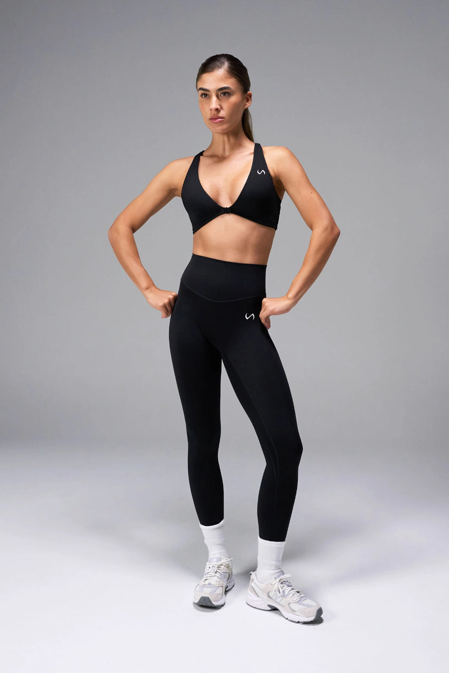 Black Tempo Front Clasp Sports Bra with Luxe DNA™ fabric and medium support for workouts and training by TLF Apparel – front view