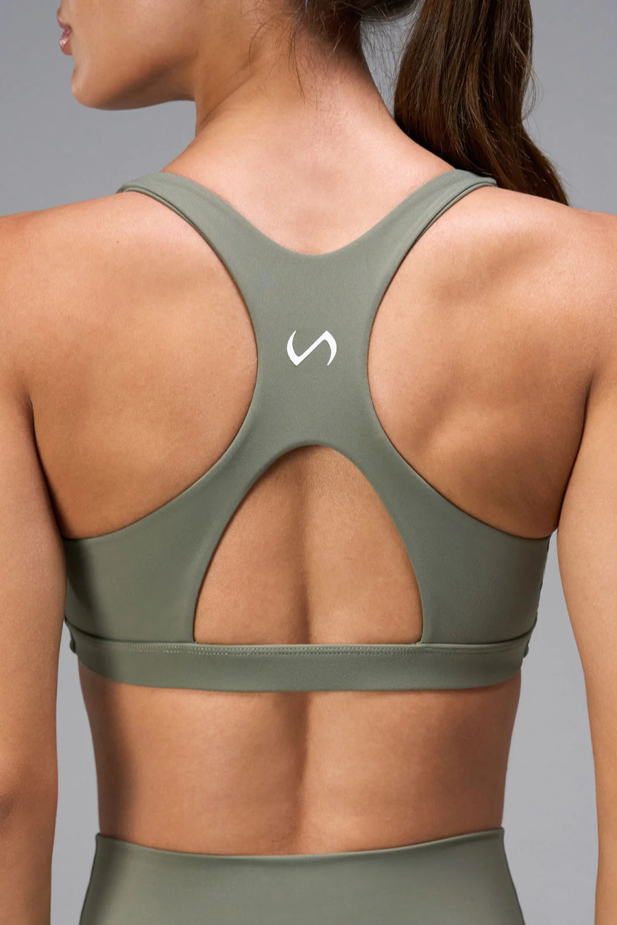 Green Tempo Front Clasp Sports Bra with supportive racerback design and medium support for training by TLF Apparel – back view