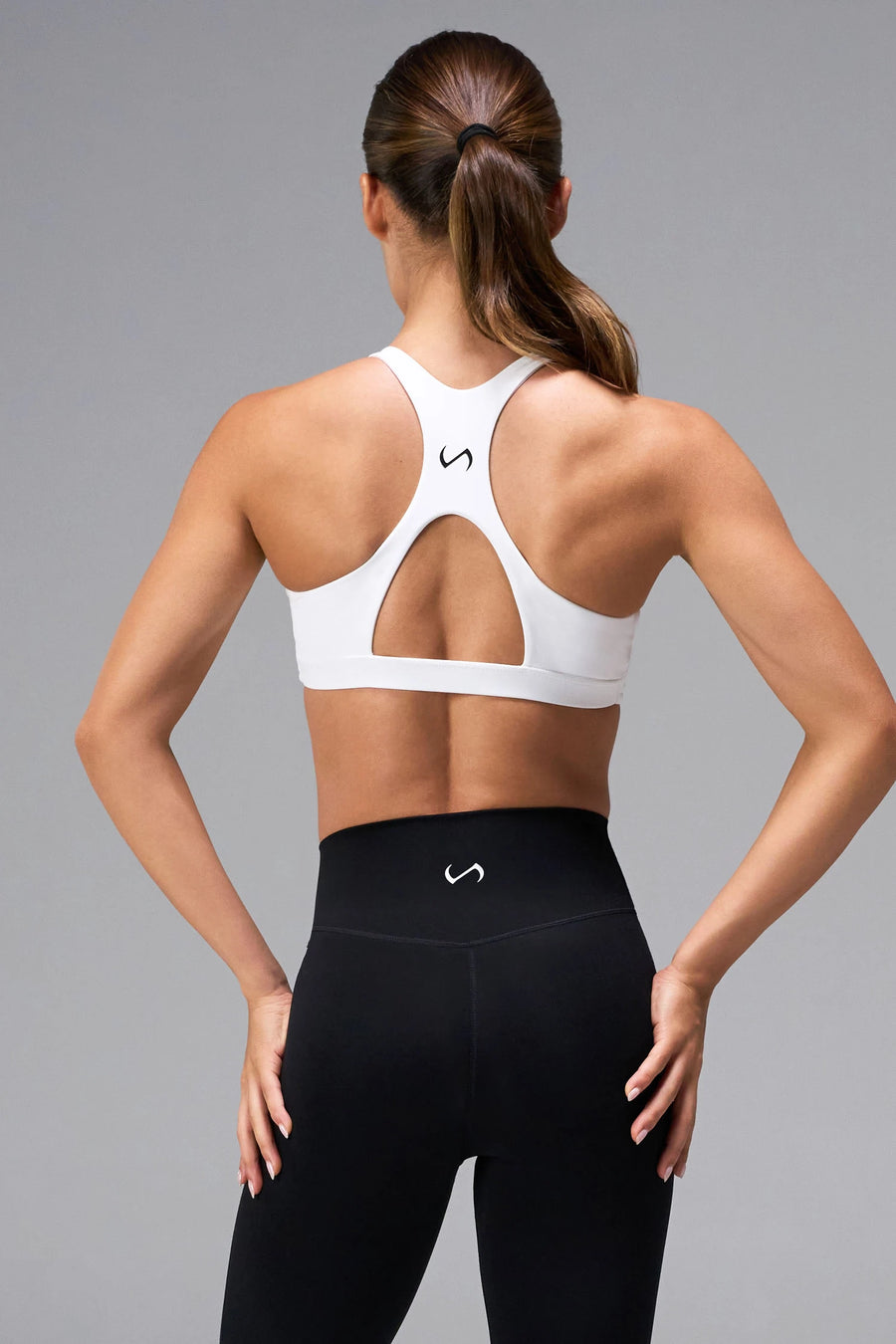 White Tempo Front Clasp Sports Bra with supportive racerback design and medium support for training by TLF Apparel – back view