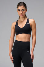 Black NeoCloud™ V-Neck Sports Bra with v neckline and medium support for the studio classes, pilates and gym training by TLF Apparel – front view 