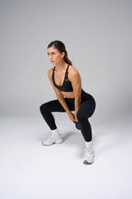 Black NeoCloud™ V-Neck Sports Bra with v neckline and medium support for the studio classes, pilates and gym training by TLF Apparel – front view 