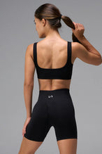Black Cosmic Seamless Open Back Sports Bra with breathable open back design and medium support for training and workouts by TLF Apparel – back view 