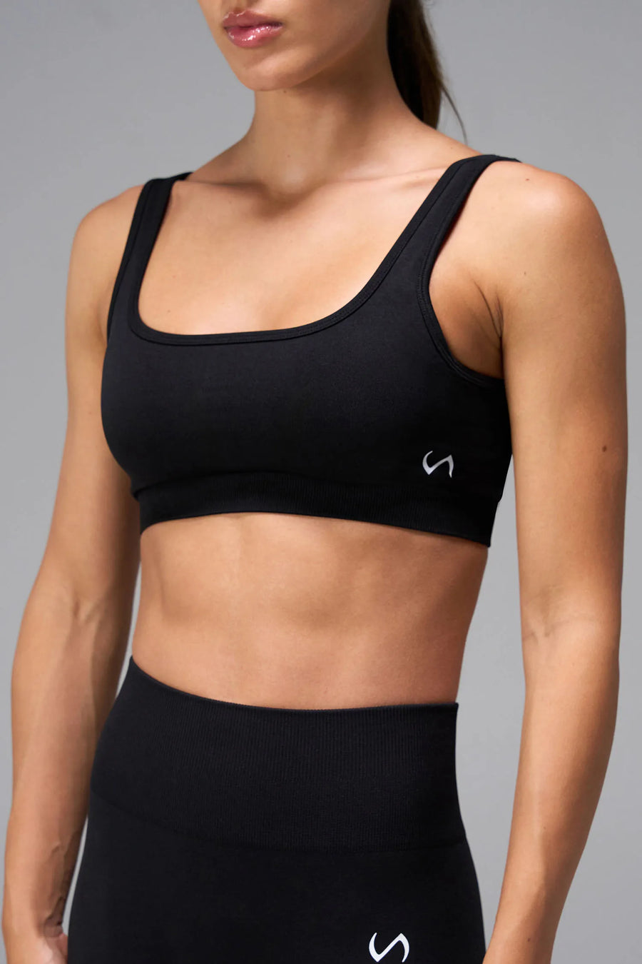 Black Cosmic Seamless Open Back Sports Bra showing sculpted side fit and seamless performance fabric by TLF Apparel – side view 