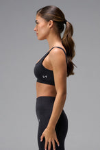 Black Cosmic Seamless Open Back Sports Bra showing fitted side silhouette and sculpting seamless fabric by TLF Apparel – side view 