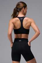 Black Tempo Racerback Sports Bra showing supportive fit and racer back straps by TLF Apparel – back view