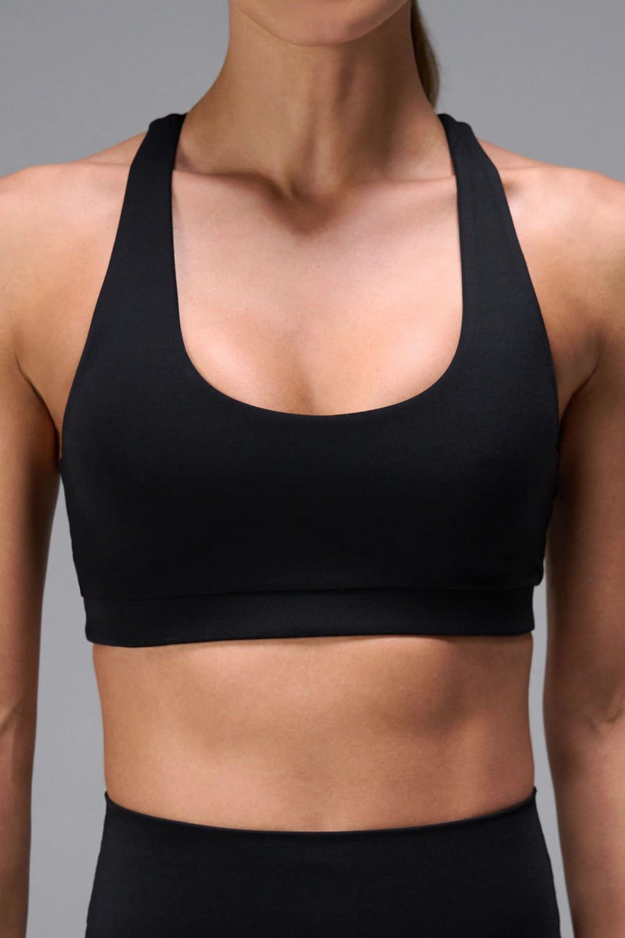 Black Tempo Racerback Sports Bra, a reversible racerback bra for Gym-To-Street® wear by TLF Apparel – front view 