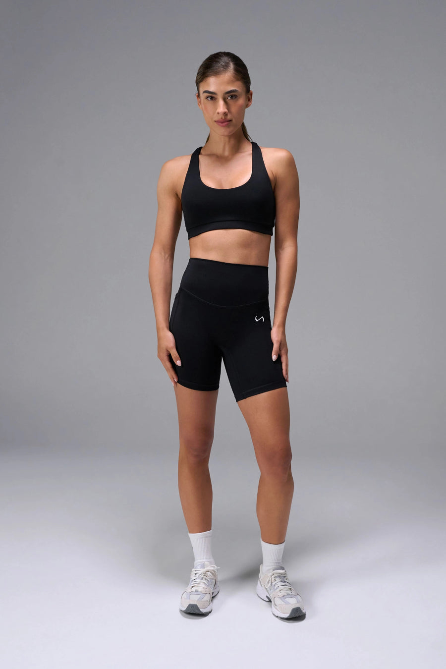 Black Tempo Racerback Sports Bra showing racerback design for full range of motion by TLF Apparel – front view
