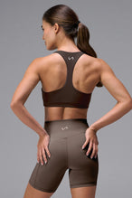 Brown Tempo Racerback Sports Bra showing Luxe DNA™ fabric texture and Hi-Tech Gel TLF logo by TLF Apparel – detail view