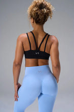 Black NeoCloud™ Strappy Sports Bra showing strappy back design and breathable cloud-soft fabric by TLF Apparel – back view